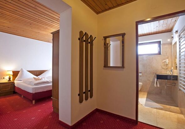 A small anteroom leading to the bedroom with a double bed and a bathroom.