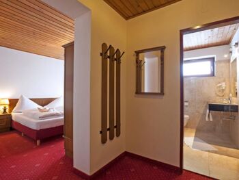 A small anteroom leading to the bedroom with a double bed and a bathroom.